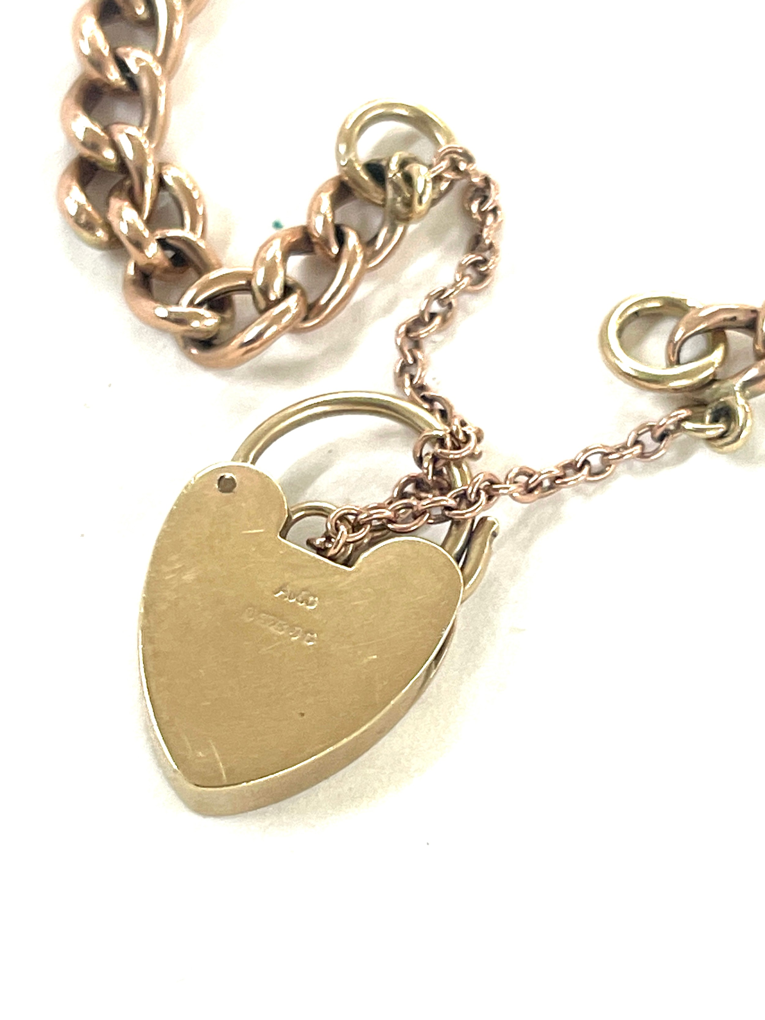 A gold chain with a heart shape locket 9 carat- weighs approx 9.6 grams
