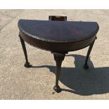 Mahogany half moon games table with ball and clawl feet measures approx when down 30 inches tall