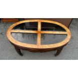 Elm and glass oval coffee table measures approximately 17inches tall 48 inches wide 29 inches depth