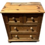 Solid pine two over two chest of drawers water damage to top measures approx 34.5 inches tall by