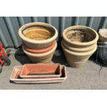 Selection of assorted plastic plant pots, largest measures approximately