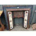 Antique cast fire place with tiles surround measures approx 40 inches tall by 39 inches wide