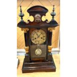Large antique Mahogany Mantle clock, with carved column supports. Wind-up movement, striking on