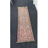 Persian style rug runner measures approximately 82 inches by 24 inches