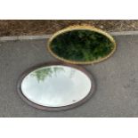 Two vintage oval shaped wall mirrors one gilt framed largest measures approx 30 inches long by 19