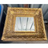 Small mirror in ornate gilt frame measures approx 19 inches wide by 15.5 inches long