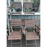 Wooden metal folding table and four chairs measures approx 48 inches wide 27 inches deep and 28