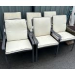 Set of six modern garden chairs with cushions and a metal and glass table