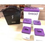 Purple and white bread bin, biscuit, tea, coffee and sugar tins together with metal post box