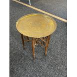 Vintage folding wooden based brass topped table measures approximately 21 inches tall 21 inches