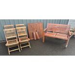 Four folding teak garden chairs, a two seater Merxx bench and a coffee table