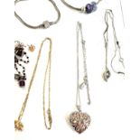 Selection of silver jewellery includes charm bracelets, pendants, chains etc