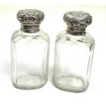 Pair of antique silver top perfume bottles London silver hallmarks each measure approx height 9cm