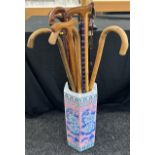 Large selection of walking sticks in a pottery stick stand