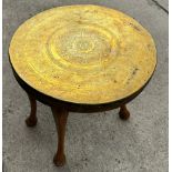 Brass topped oak legged occassional table measures approx 20 inches diameter and 19 inches tall