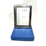 Boxed silver picture frame m easures approx 22cm by 17cm