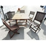 Teak folding table with 5 assorted teak chairs