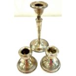 Pair of hallmarked sterling silver candlesticks plus one other