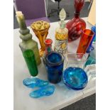 Selection of vintage and later coloured glass includes decanters etc