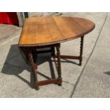 Oak barley twist gate leg table measures approx 29 inches tall by 42 inches wide