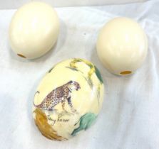 Two ostrich eggs and a hand painted signed egg