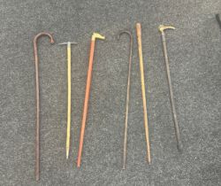 Selection of vintage walking sticks one with brass horse head etc