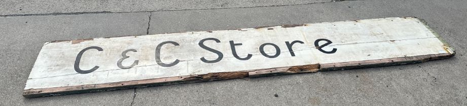 Vintage wooden shop sign ' C&C Store' measures approx 107 inches long by 19 inches tall