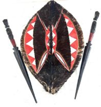 African shield and 2 wooden carved swords, shield measures approximately 24 inches by 15 inches