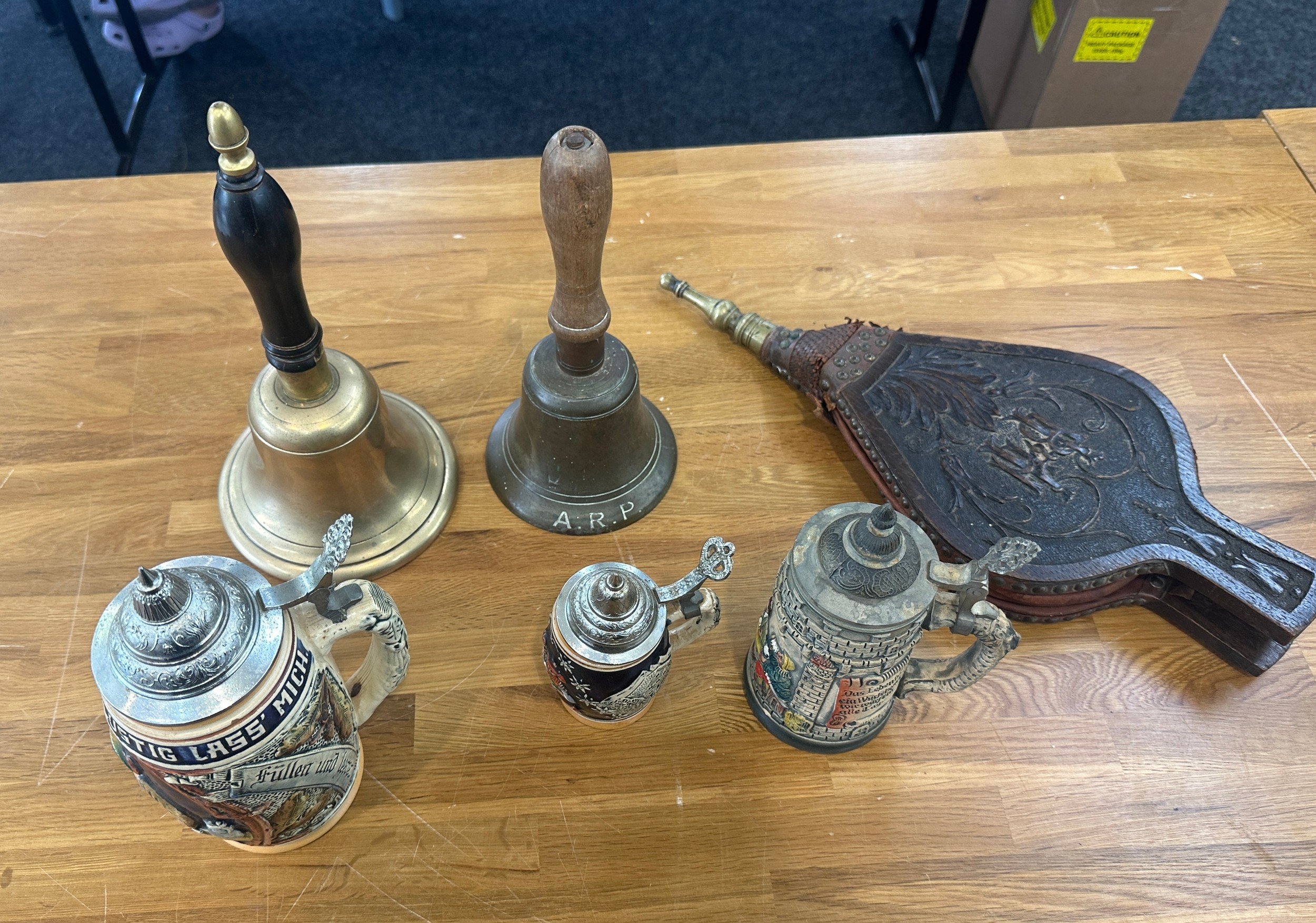 Selection of vintage collectables to include German steins, brass school bells one marked A.R.P etc