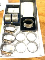 Large selection of assorted napkin rings includes cased mapin and webb and a cased silver napkin