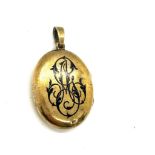 Antique yellow metal and enamel locket containing a lock of hair weight 18grams size 3.5cm by 2.6cm