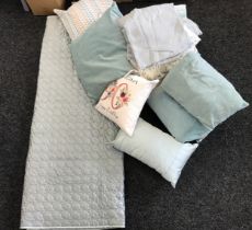 Large selection of assorted cushions and bedding