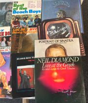 Selection of assorted records includes family, neil diamond, golden hits, beach boys, paint it black