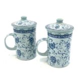 Pair of vintage oriental porcelain tea cups with strainers, marks to the base, approximate height