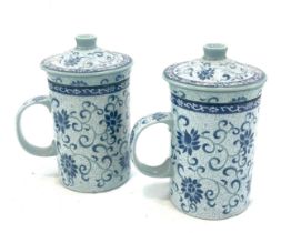 Pair of vintage oriental porcelain tea cups with strainers, marks to the base, approximate height