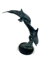 Metal dolphin sculpture on a wooden plinth 15 inches tall