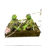 A Micheal Tallis creation of two automated rowing frogs for display measures approx 13 inches tall