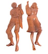 Pair of wooden figures, height approximately 24 inches tall