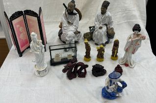 Selection of oriental items to include two mud men figures, resin dragon and buddha figures etc