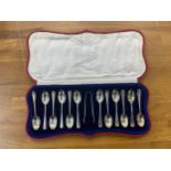 Cased set of 12 silver tea spoons and sugar tongs, makers marks CJDF