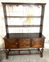 Open back oak Welsh dresser, fielded panels to door and side, approximate measurements: Height 74