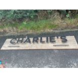 Large advertising "Charlies" sign, measures approximately 95 inches long 19 inches depth