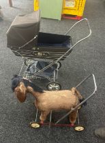 Children's vintage pram with a donkey on wheels