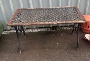 Cast iron garden table with cast iron top measures approx 46 inches wide by 25 inches tall