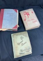 Vintage photo albums with old photographs and a vintage cigarette card album