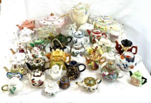 Large selection of miniature teapots, various designs and makers