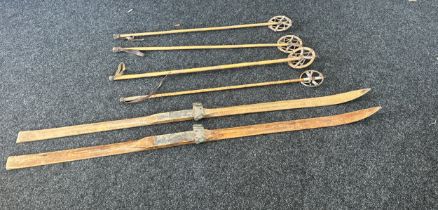 4 Vintage ski poles together with a set of wooden ski's