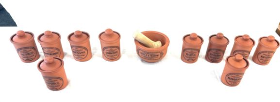 Selection of terracotta henry watson spice jars, pestle and mortar etc