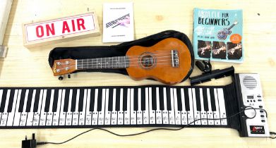 Hand roll piano, tiger ukulele musical instrument, small on air box etc