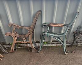 Pair of cast iron bench ends one with wooden arms